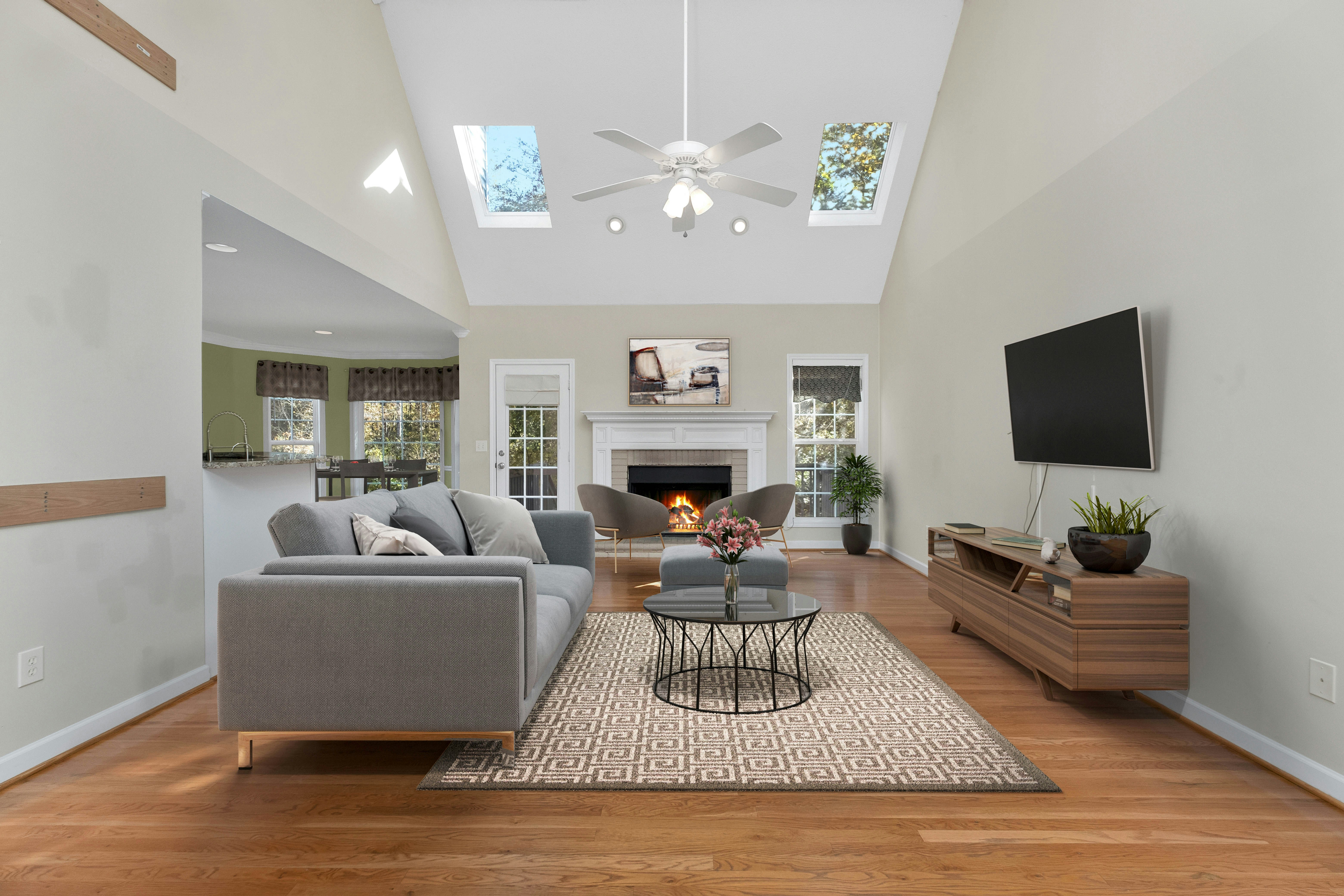 Staged living room with high ceilings, modern furniture, and open layout