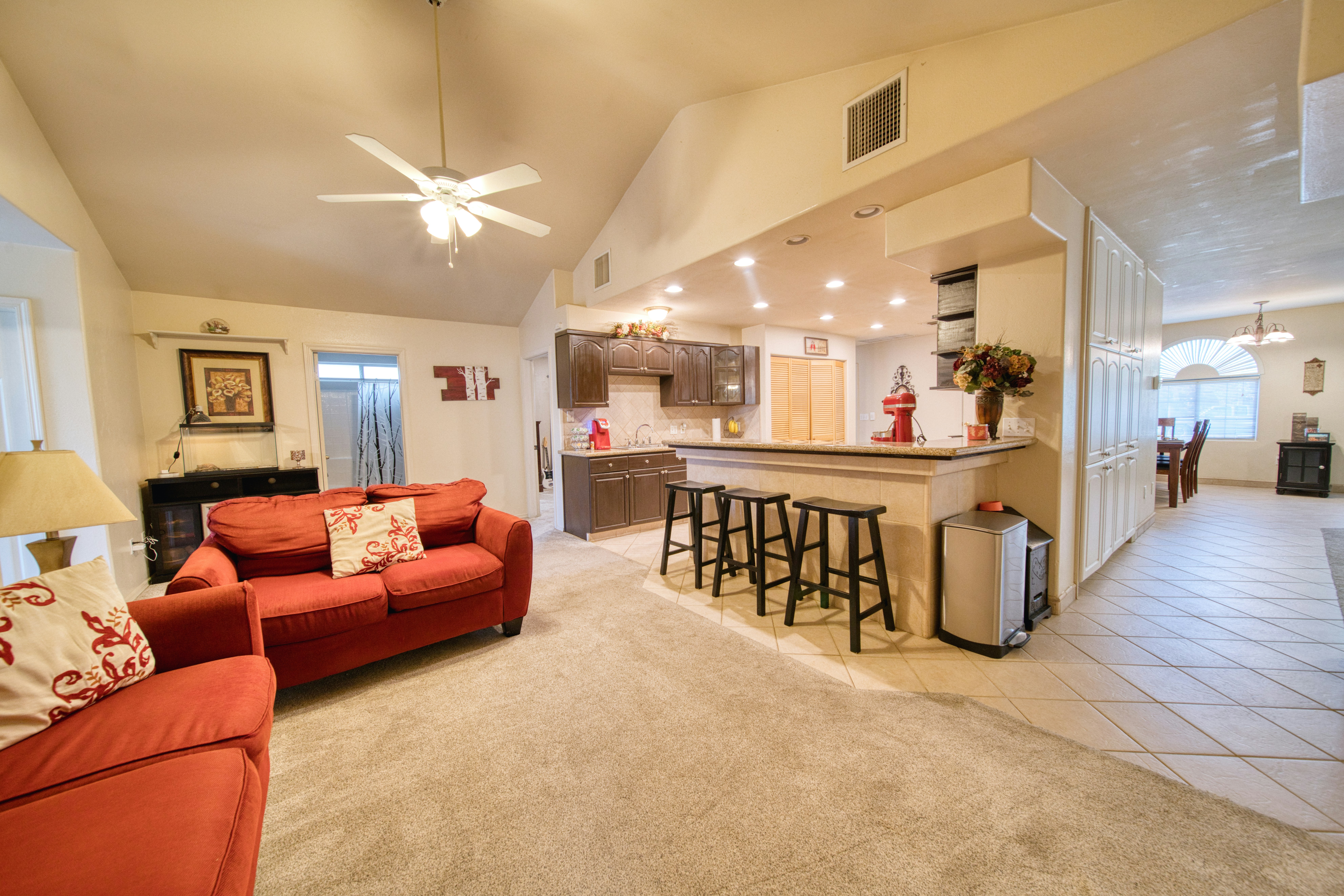 Open concept living and kitchen staging with warm tones and inviting seating