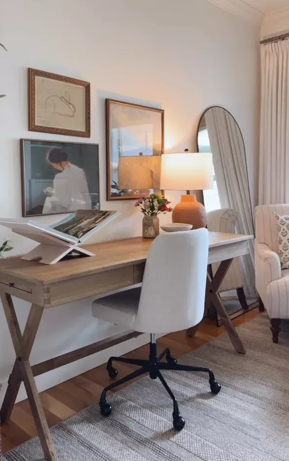 Staged home office with wooden desk, chair, and soft neutral styling