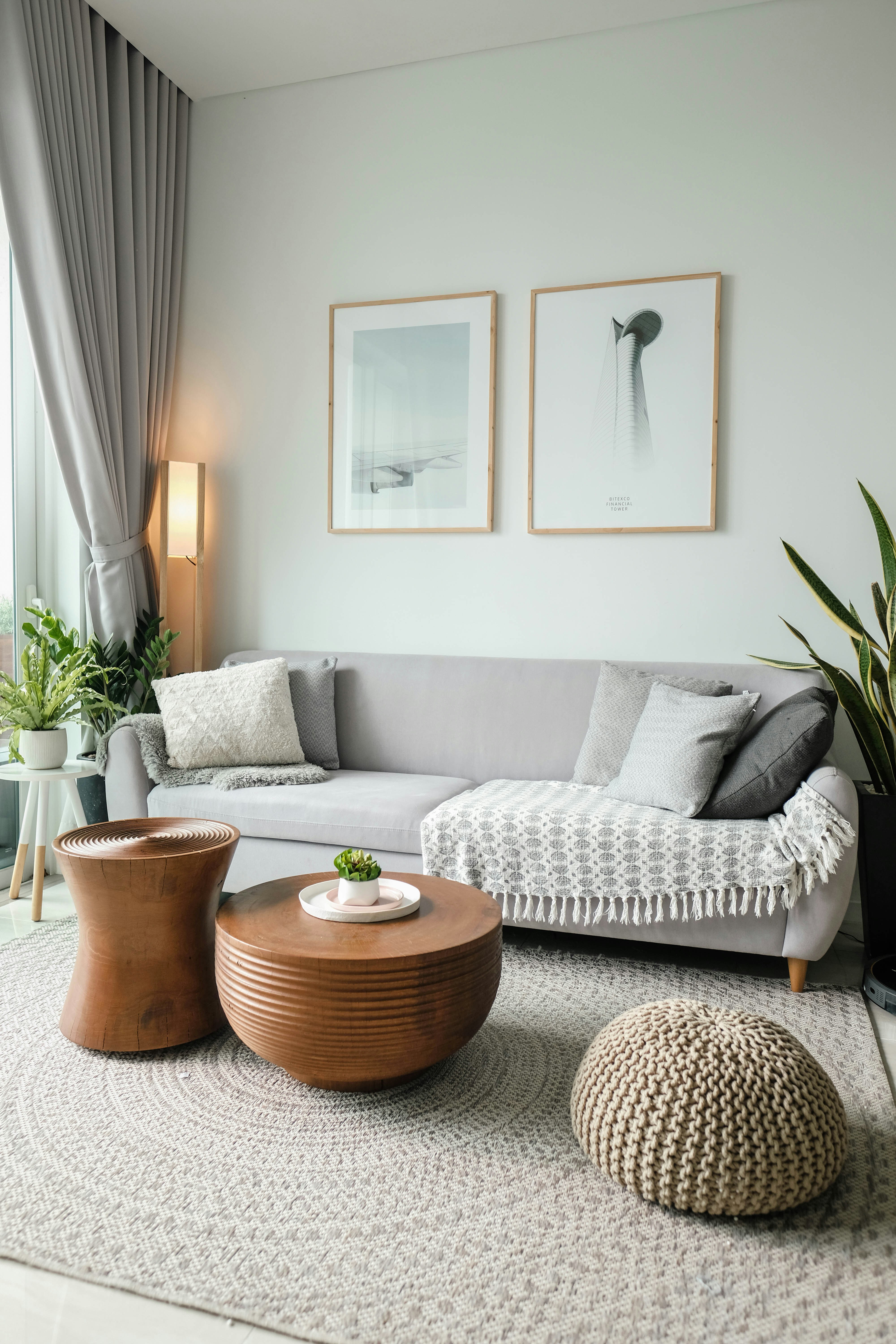 Bright modern living room with neutral furniture, indoor plants, and soft natural lighting creating a calm, welcoming space
