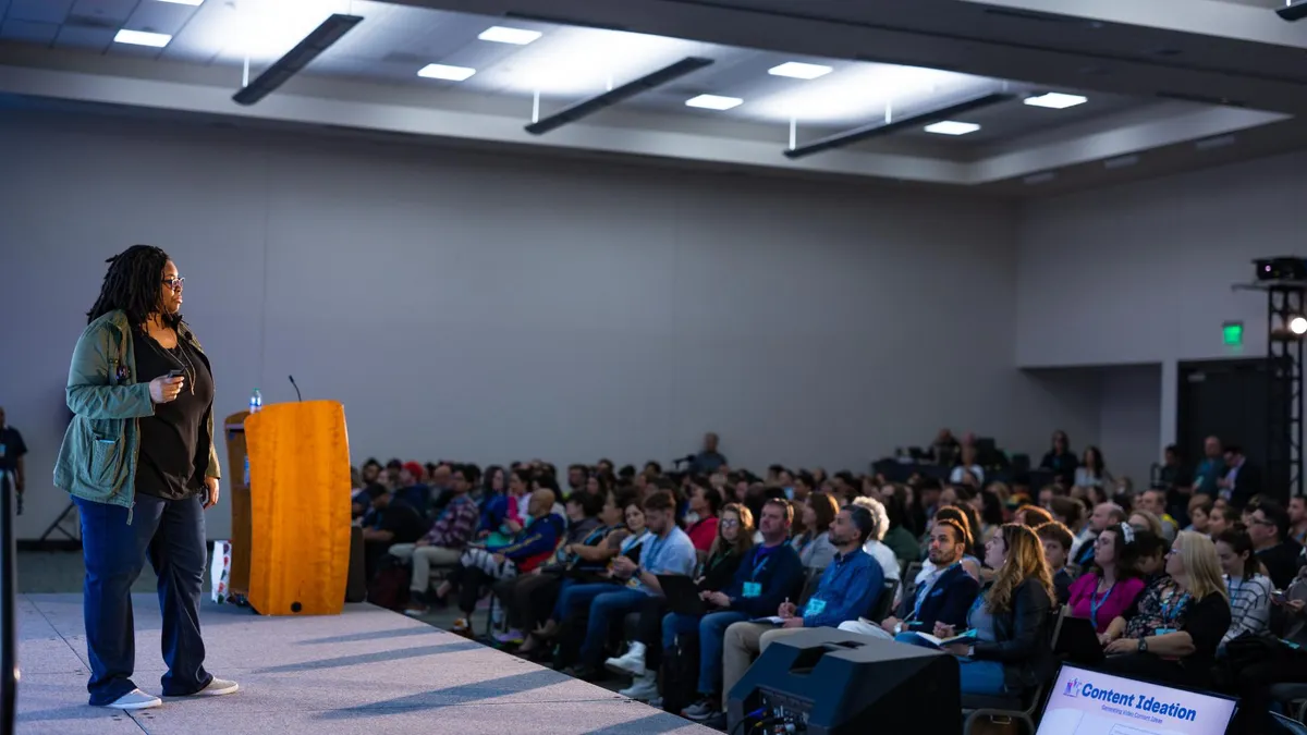 Diana Gladney speaking on stage to an audience about video strategy