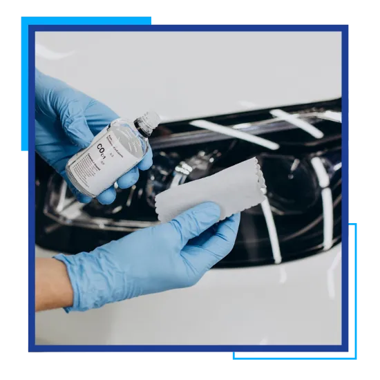 Ceramic installer applying paint protection with careful surface preparation