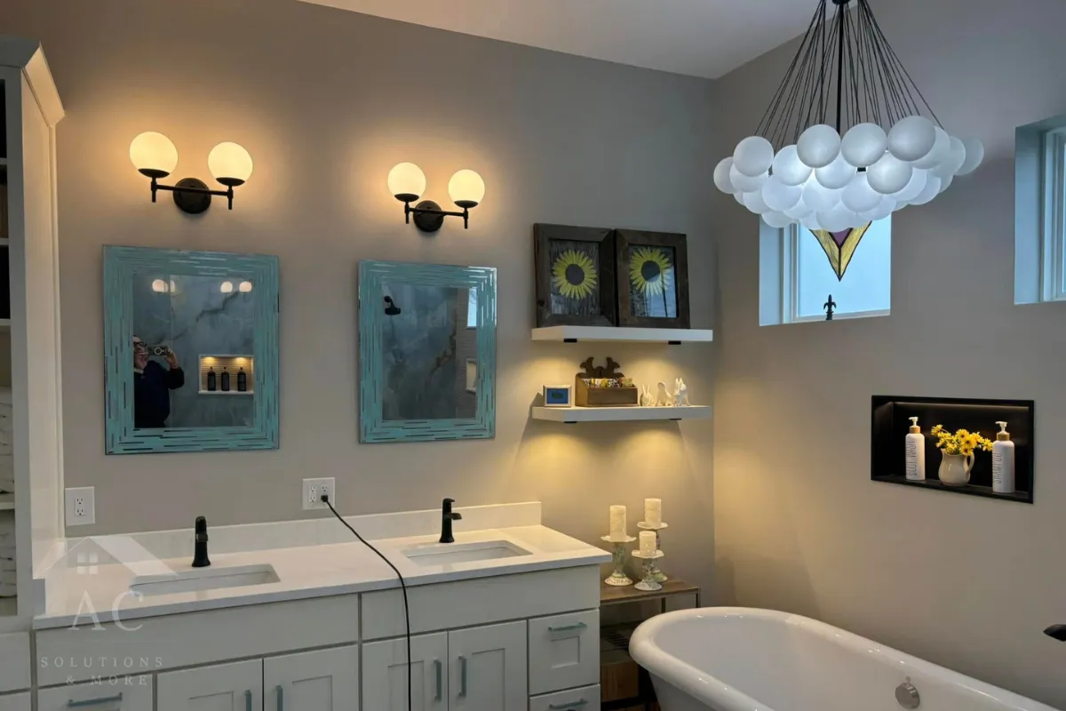 Traditional bathroom with freestanding tub, twin sink vanity, and decorative wall lighting