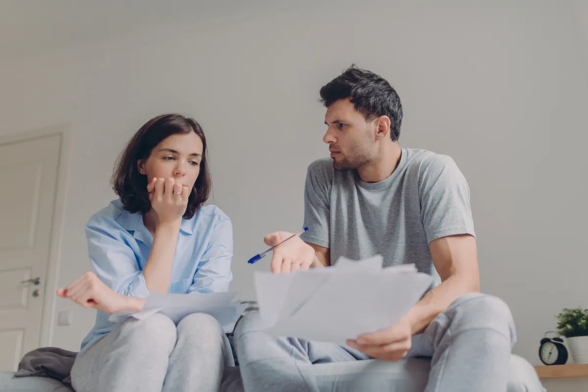 worried Vancouver parents discussing family financial security and life insurance protection