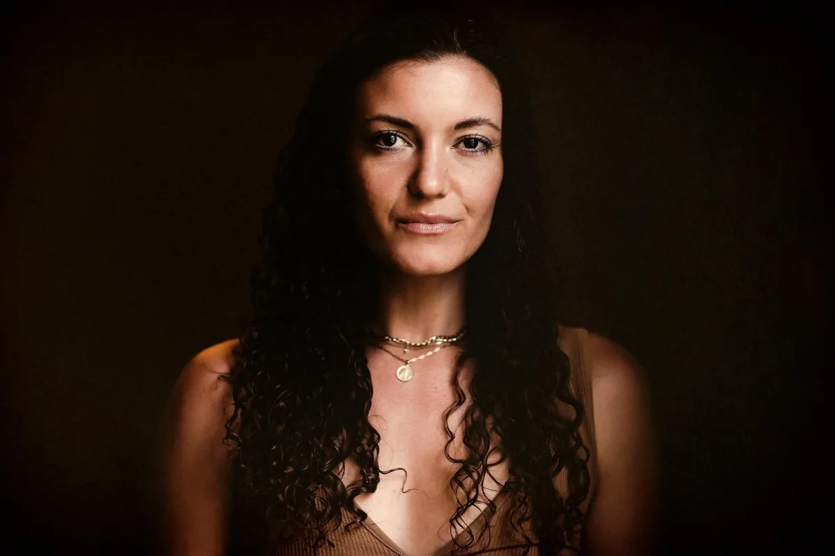 Kendall Merritt, Woman with long curly hair in a brown top
