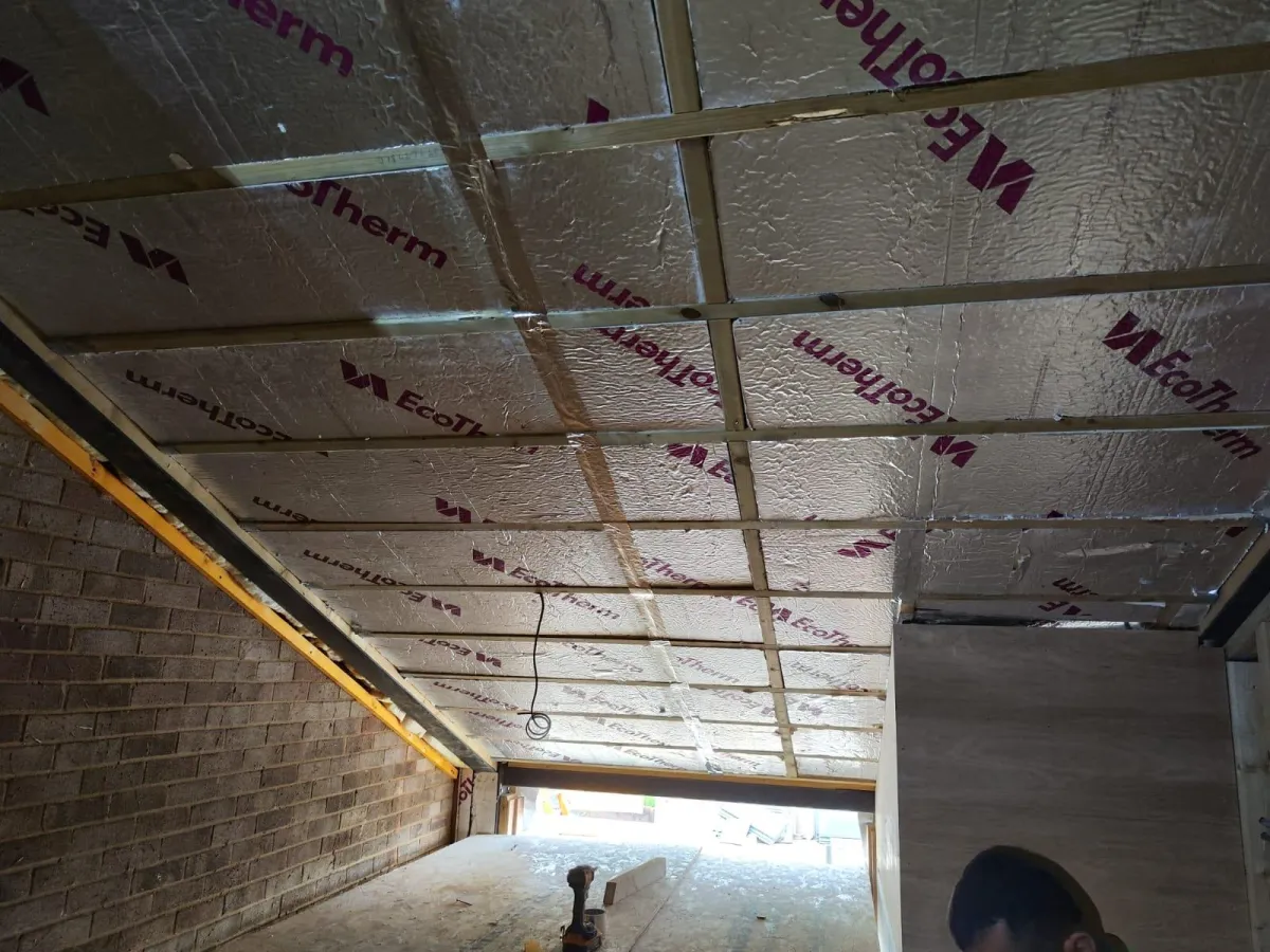 Carpenter installing wood framing during a home renovation project