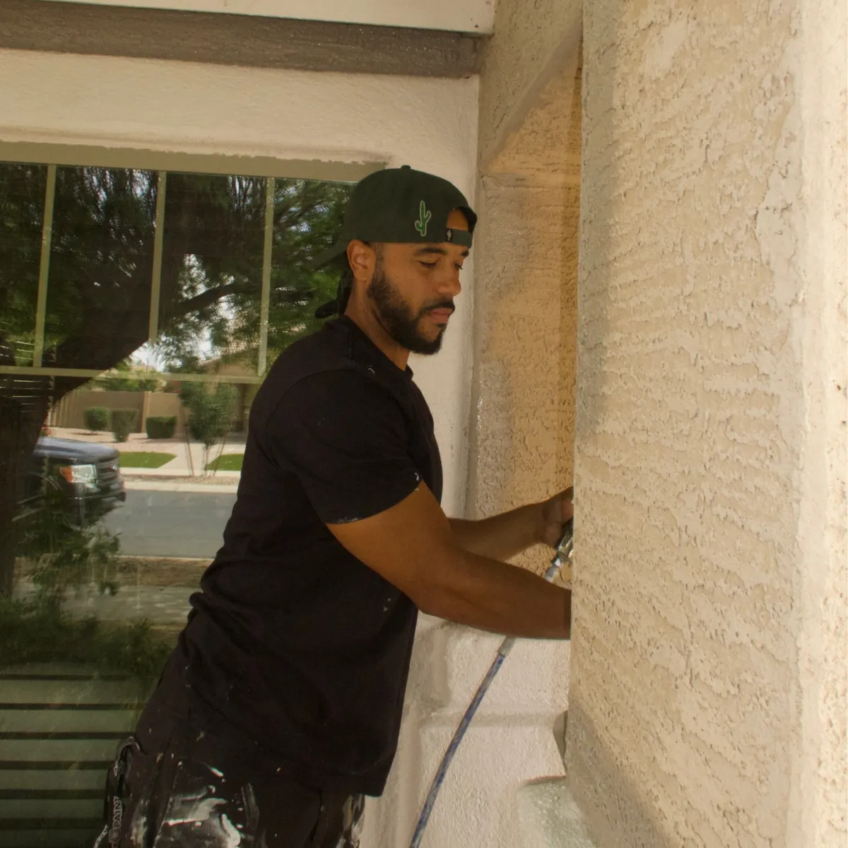 Professional residential painting crew working on a modern home exterior