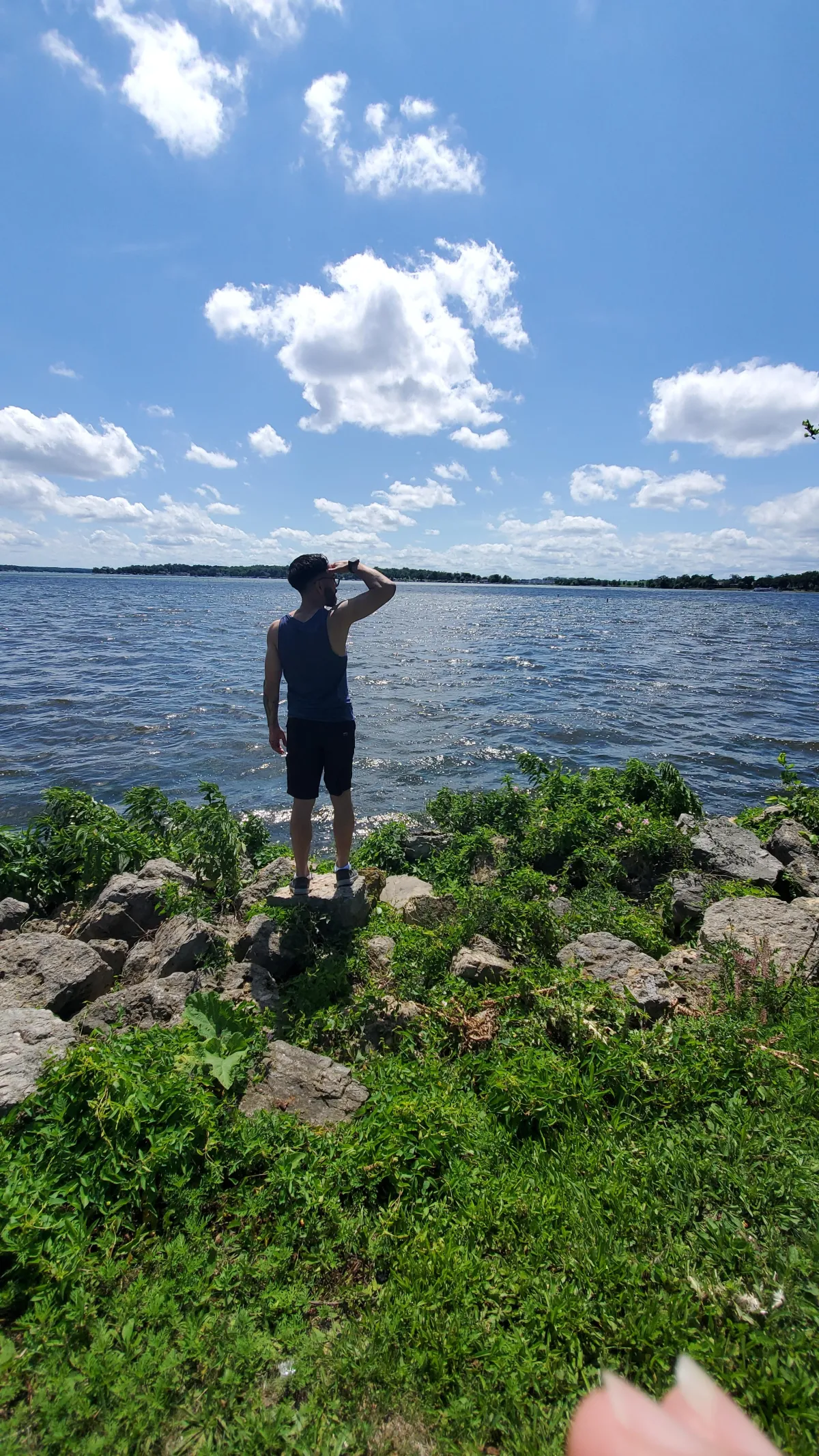 a woman standing on a bridge with her arms crossed