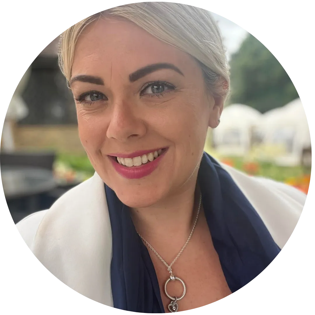 Portrait photo of Nikki, business mentor and founder of Inspire UK, smiling outdoors.