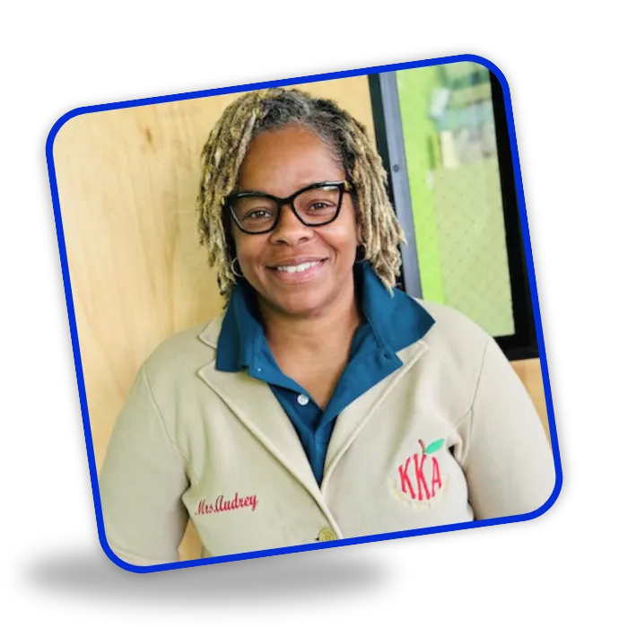 Audrey McNulty, owner of Kingdom Kidz Academy in Piscataway, NJ, smiling and standing proudly in her academy jacket, welcoming families to explore their childcare programs.