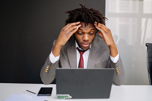 Person Stuggling in front of computer frustrated