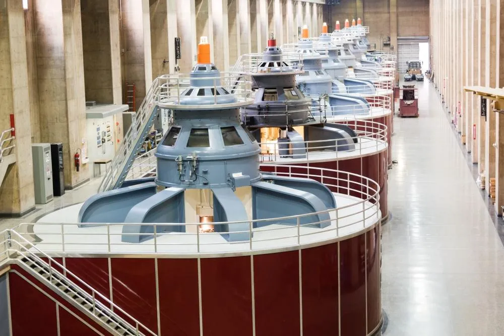 Multiple hydroelectric turbines aligned in a large generation facility – showcasing ETS excitation system service area