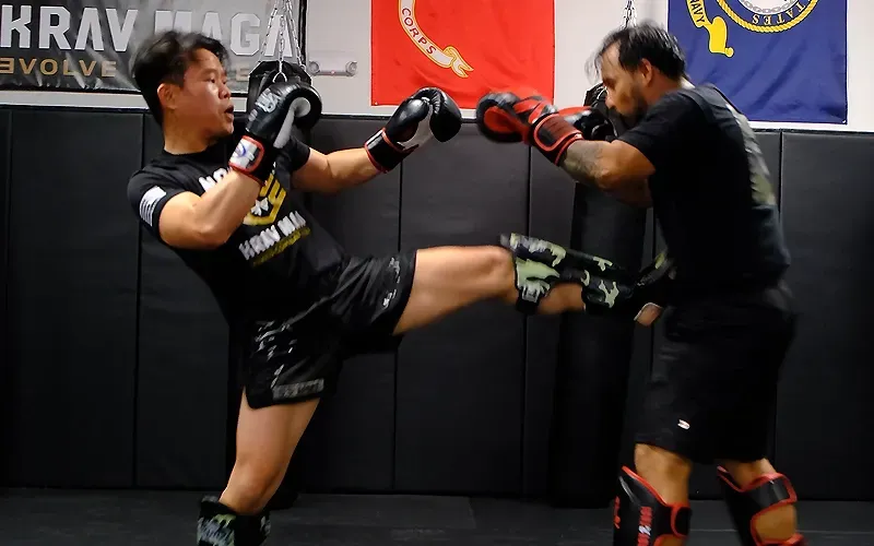 Adult students practicing Muay Thai and boxing inspired kickboxing and striking techniques at Nomad Mixed Combat HQ as part of a complete real-world self-defense coaching system.