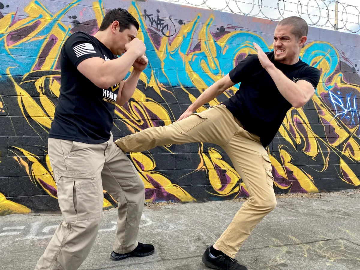 Shannon Langwell demonstrating realistic self-defense techniques in an outdoor training scenario as part of the Nomad Mixed Combat HQ coaching system.