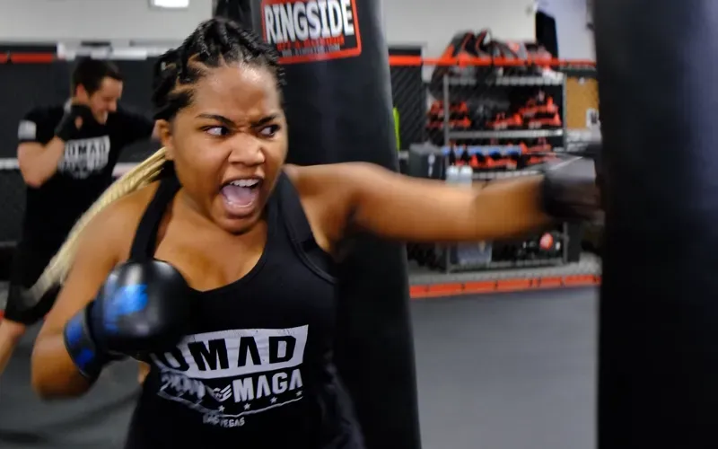 Adult student building confidence, strength, and real-world self-defense skills during heavy bag training at Nomad Mixed Combat HQ in Fort Smith, Arkansas.