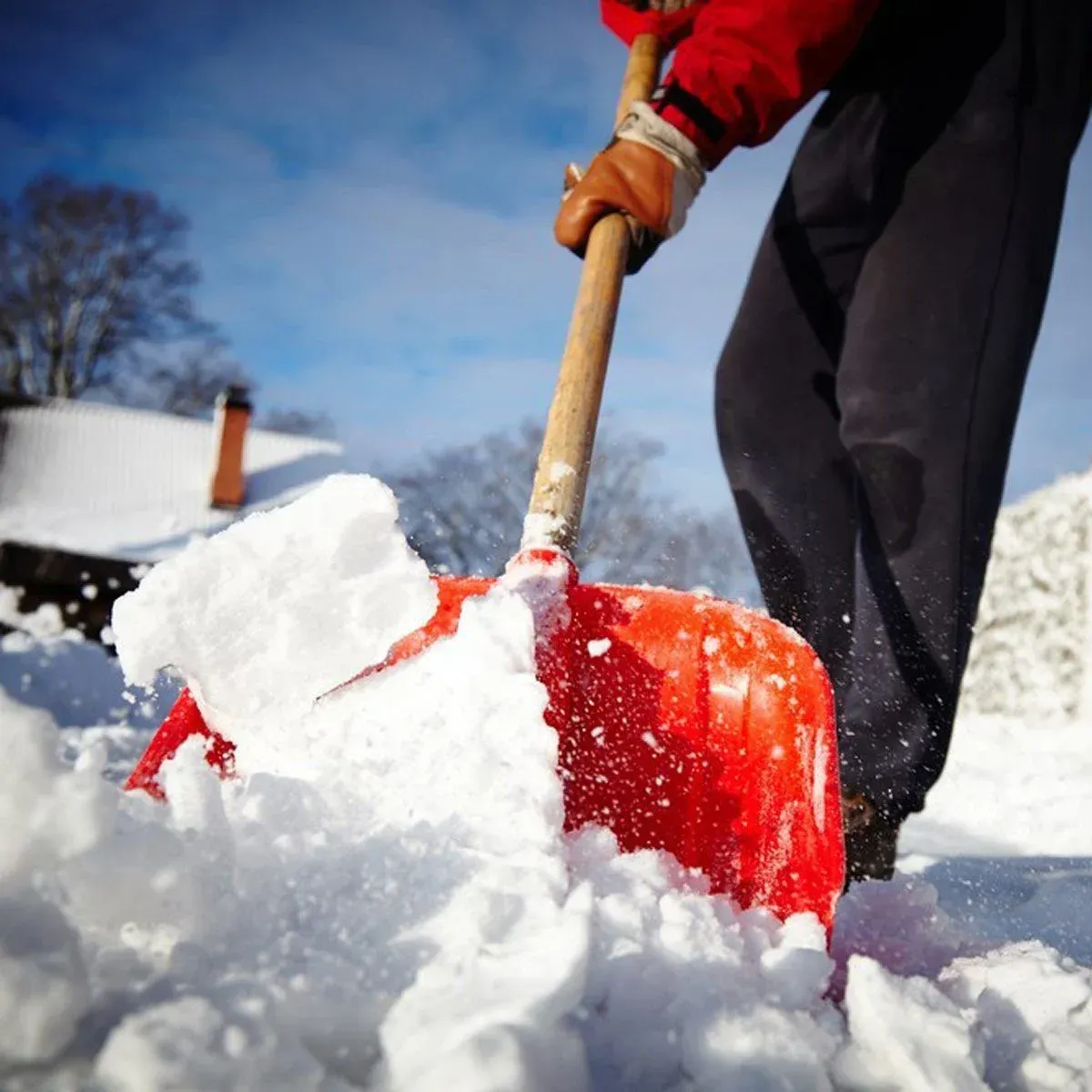 snow and ice removal service creating a clear path in front of a business