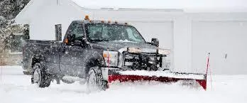 Snow removal truck in Calgary clearing snow from a parking lot.