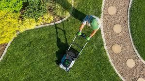 Lawn maintenance services in action, including trimming and weed control.