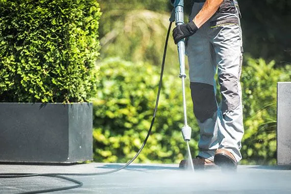 Commercial power washing service cleaning the exterior of a large building