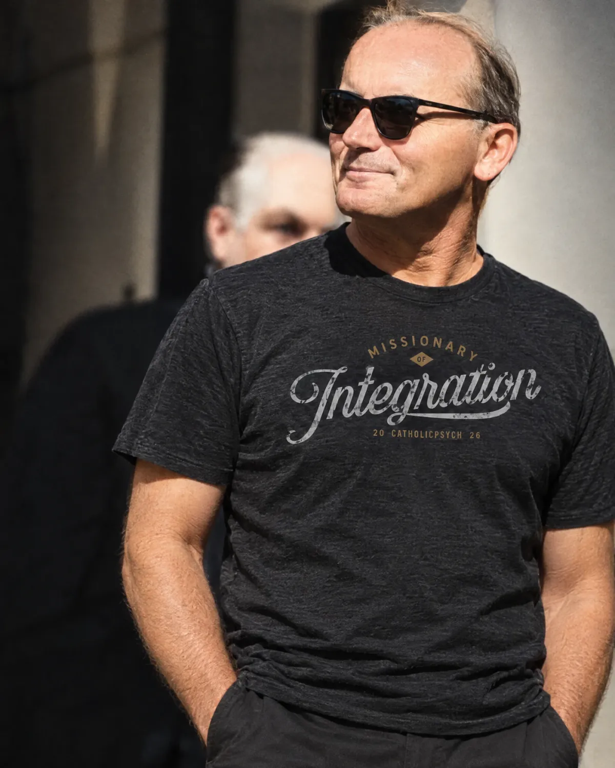 AI-created illustration showing the Missionary of Integration T-shirt, with gray script and gold CatholicPsych lettering