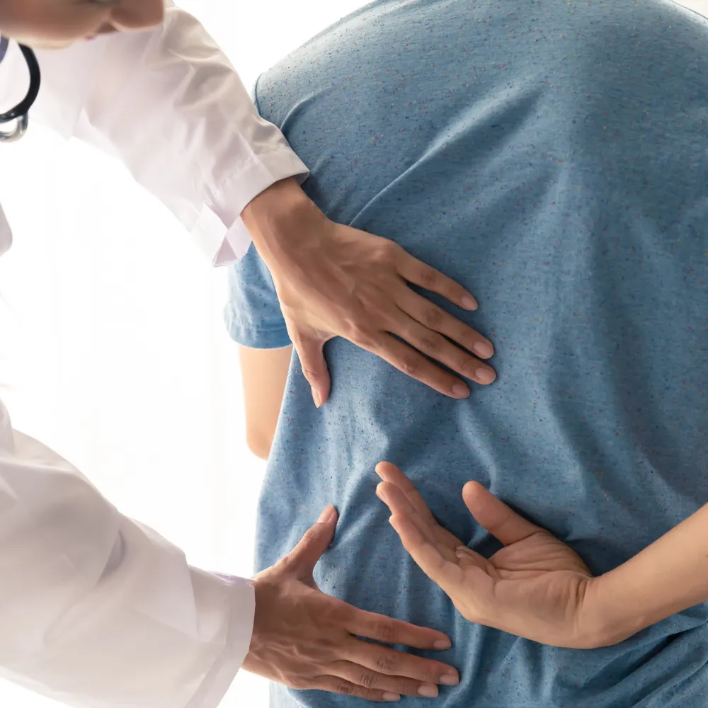 Worker experiencing back pain from job-related strain, illustrating work-related injury chiropractic care