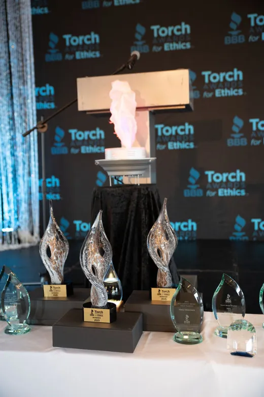 Past winners of the BBB Torch Awards holding their trophies at the gala