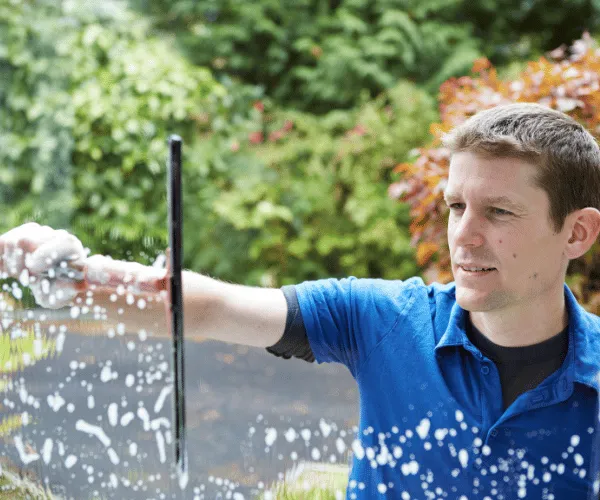 Professional cleaning commercial storefront windows in downtown Spokane