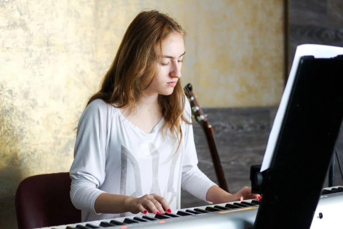 Teen piano student at a Nordiska upright piano during a private lesson at a Farmington, Utah music school.