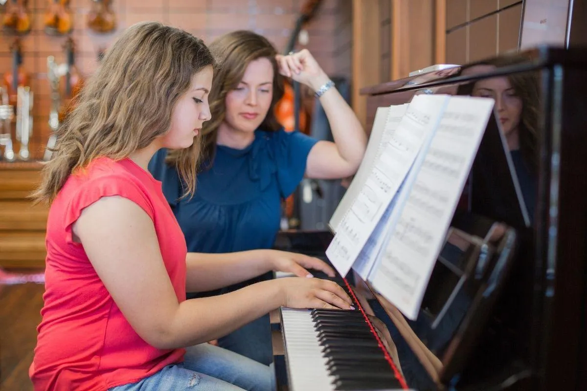 Teen piano student at a Nordiska upright piano during a private lesson at a Farmington, Utah music school.