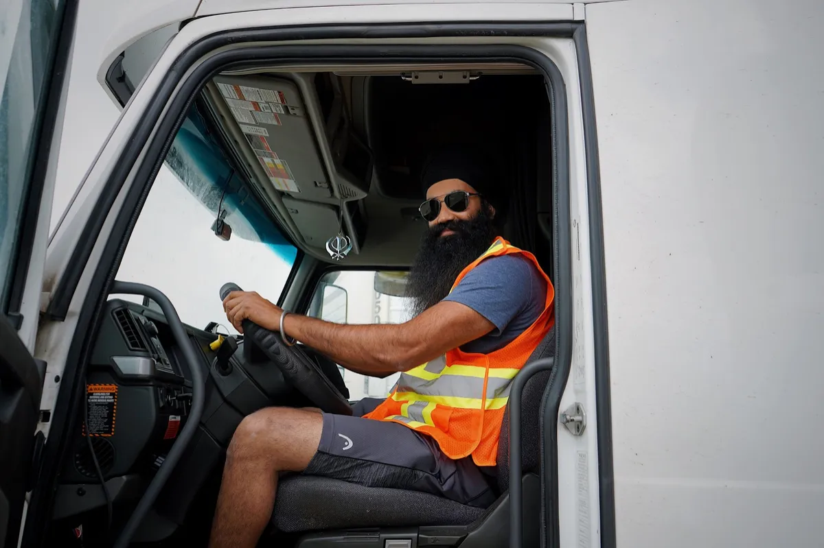 Professional truck driver inside commercial truck