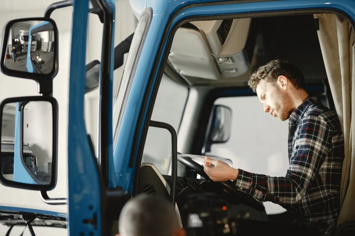 Truck driver reviewing a compliance checklist