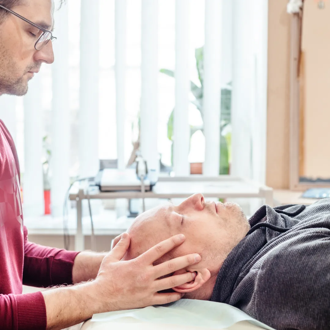 therapist treating the bones of the patient's skull