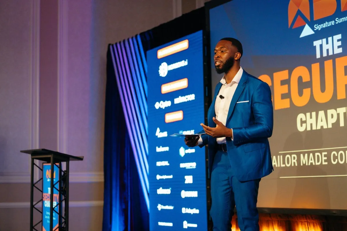 Nde Nkimbeng on stage hosting a tech conference