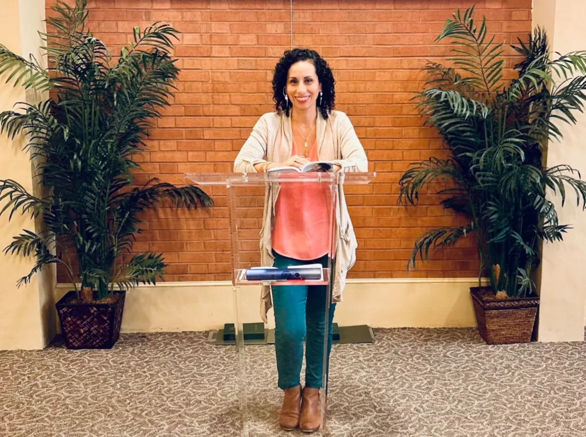 Yung child looking at yellow wall with the words Believe in yourself