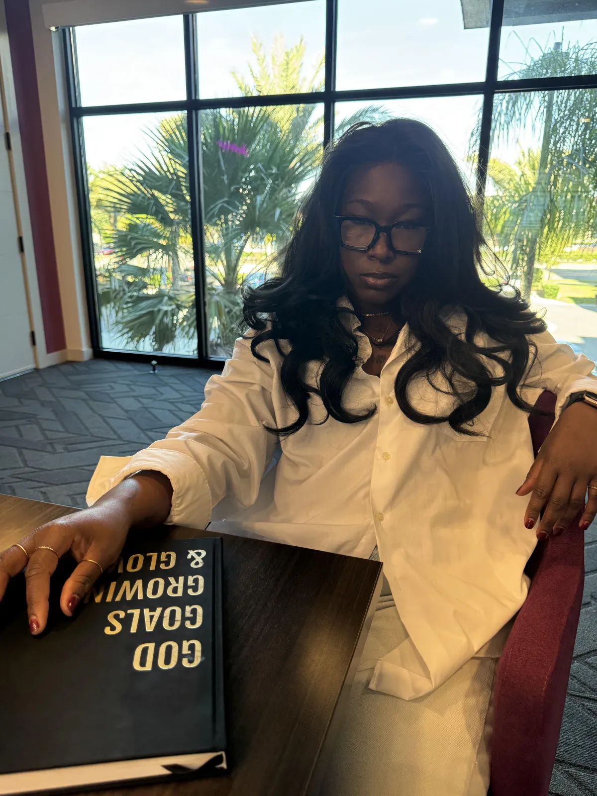 Close-up of a whiteboard with annotated ROI charts and sticky notes, revenue curves, percent uplift callouts in purple, and a hand pointing to metrics.