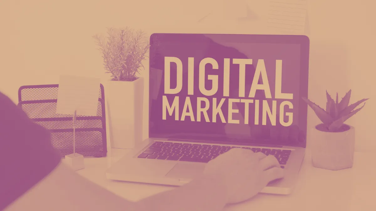 computer with digital marketing on screen in orange and pink