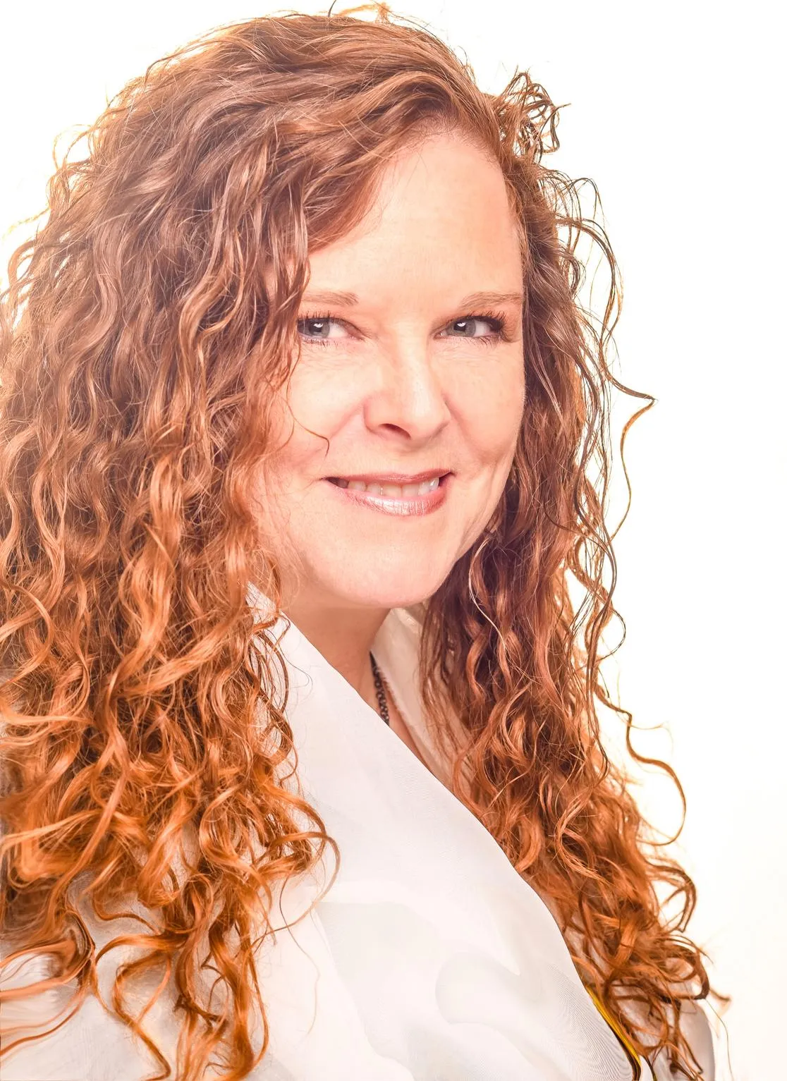 A smiling man wearing glasses in an office setting.