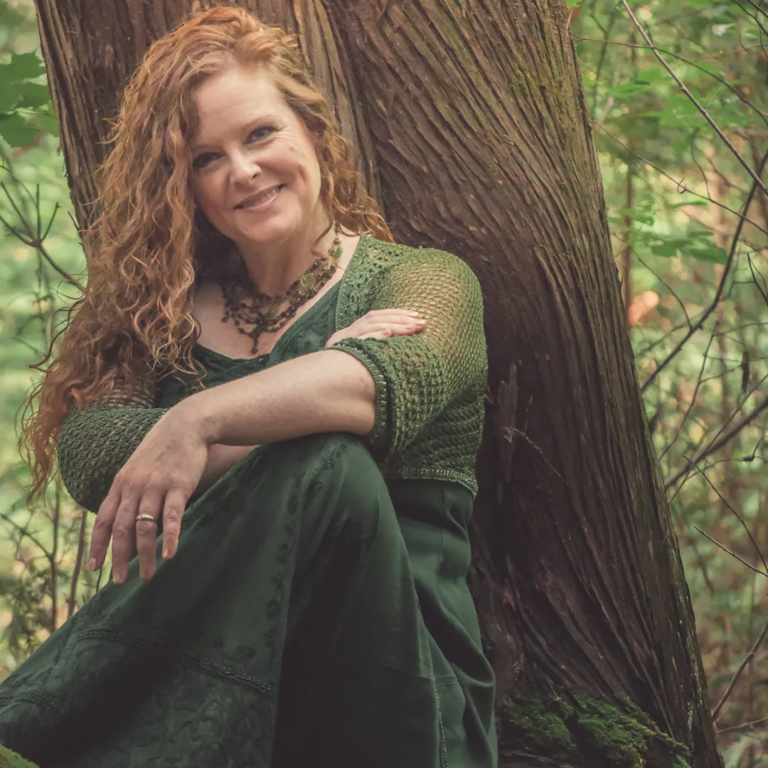 A smiling man wearing glasses in an office setting.