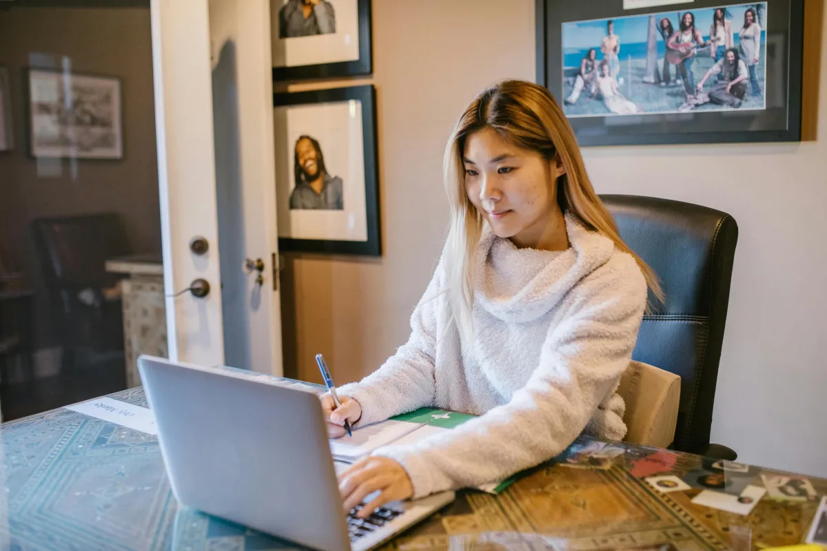 woman sitting at a desk using her computer
