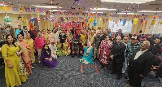 Caregiver assisting elderly client with daily living activities at home