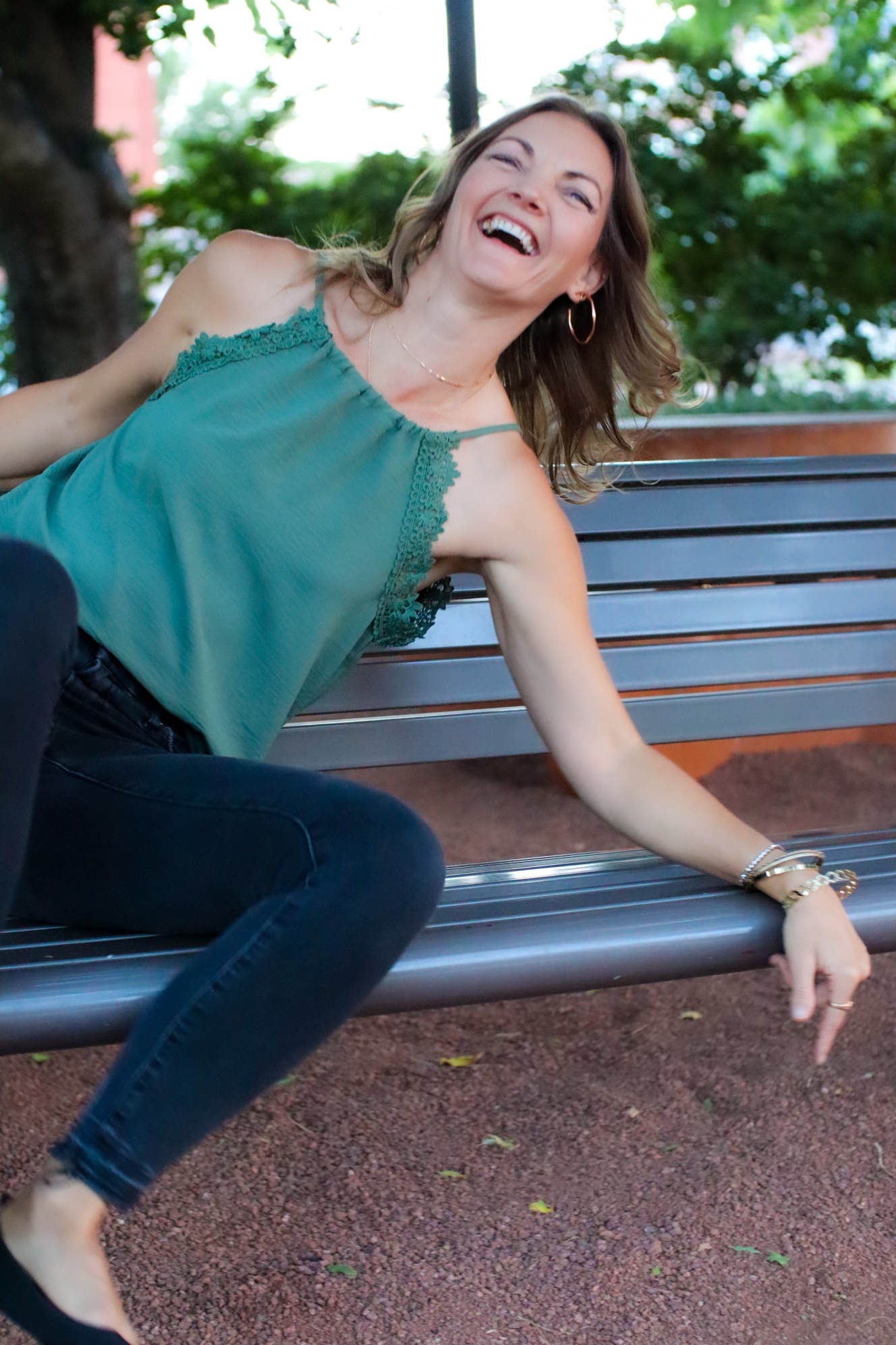 Jessica outdoors practicing gentle yoga in a sunlit forest clearing