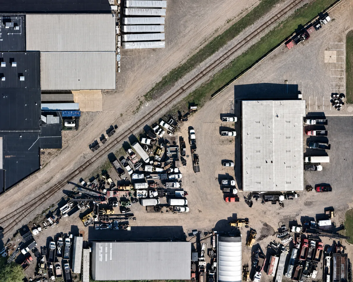 Aerial view of Main Executive’s Appleton, Wisconsin facility with commercial trucks, trailers, and construction equipment.