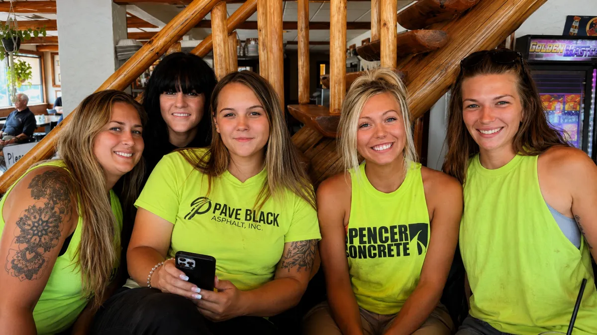 Pave Black Asphalt and Spencer Concrete team members wearing branded shirts at a company gathering in Appleton, Wisconsin.