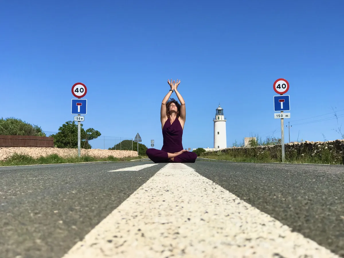 woman in black tank top and black pants doing yoga