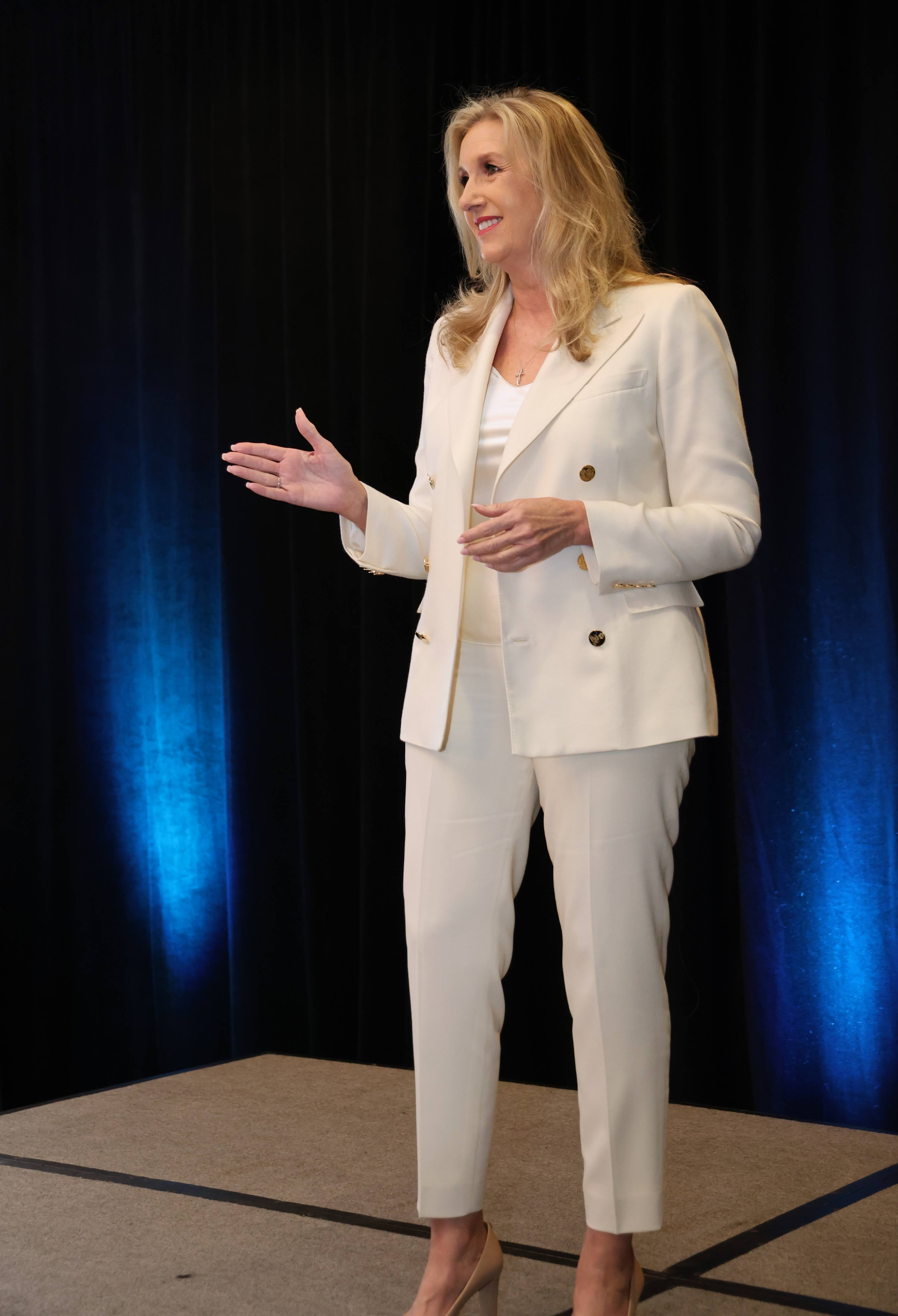 Julie Jones delivering a keynote presentation on stage.