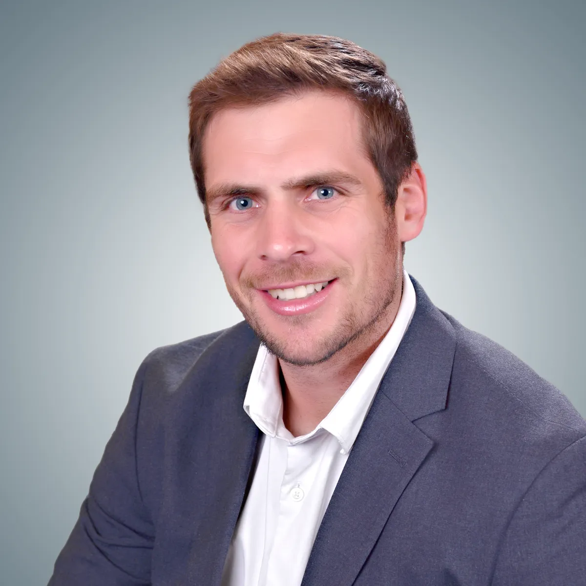 Headshot of Coach Matthew McNab—smiling, professional, wearing business attire.