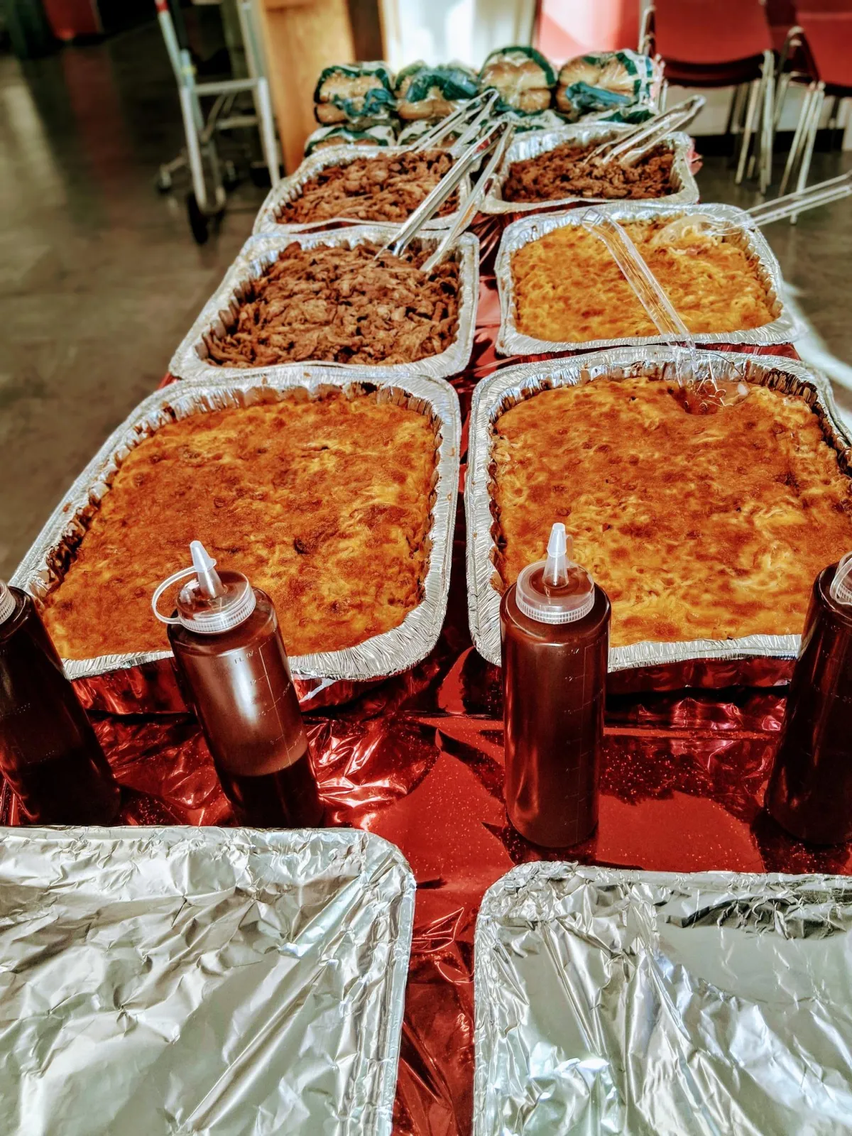 a group of people cooking on a grill outside