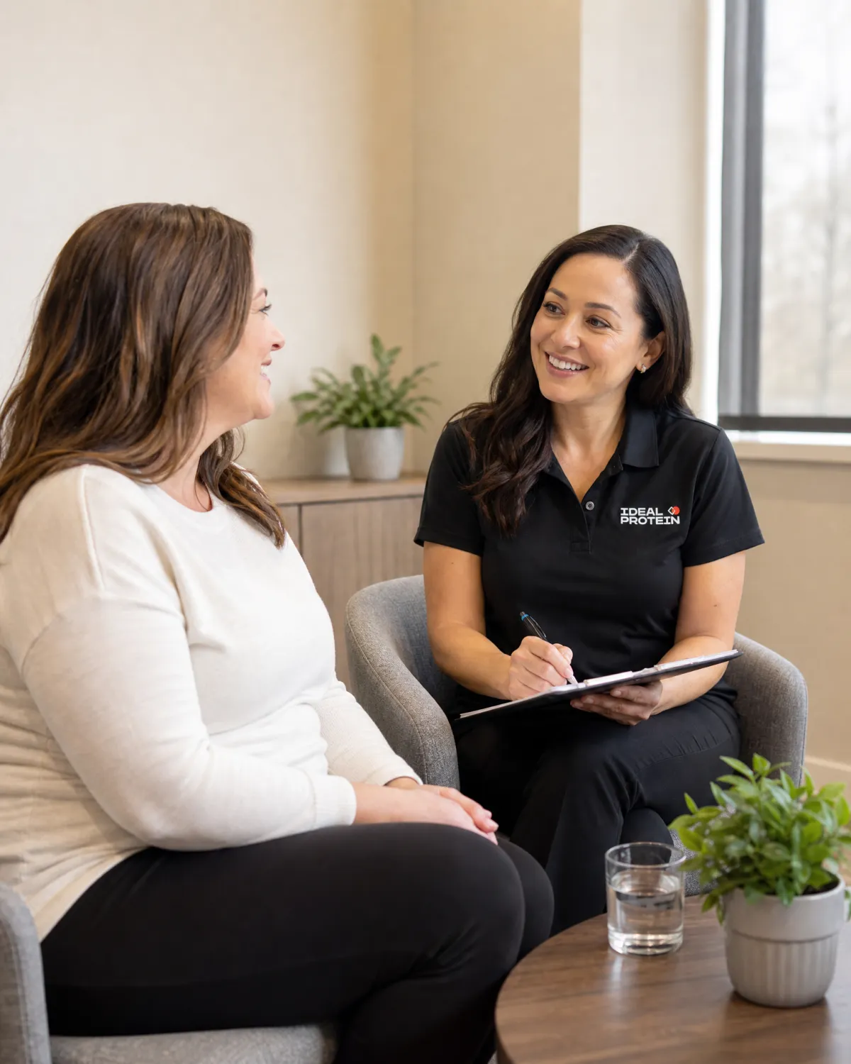 Certified Ideal Protein coach meeting one-on-one with a client to provide personalised guidance and accountability