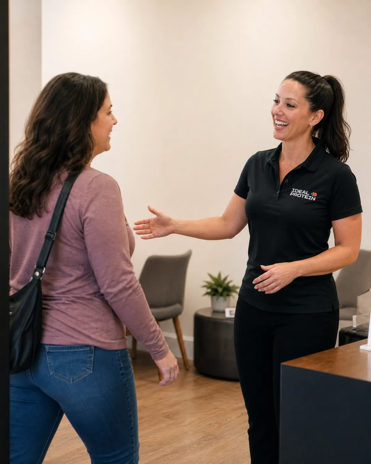 Certified Ideal Protein coach meeting one-on-one with a client, representing the weekly coaching and gradual plan adjustments available through the Ideal Protein restart weight loss program