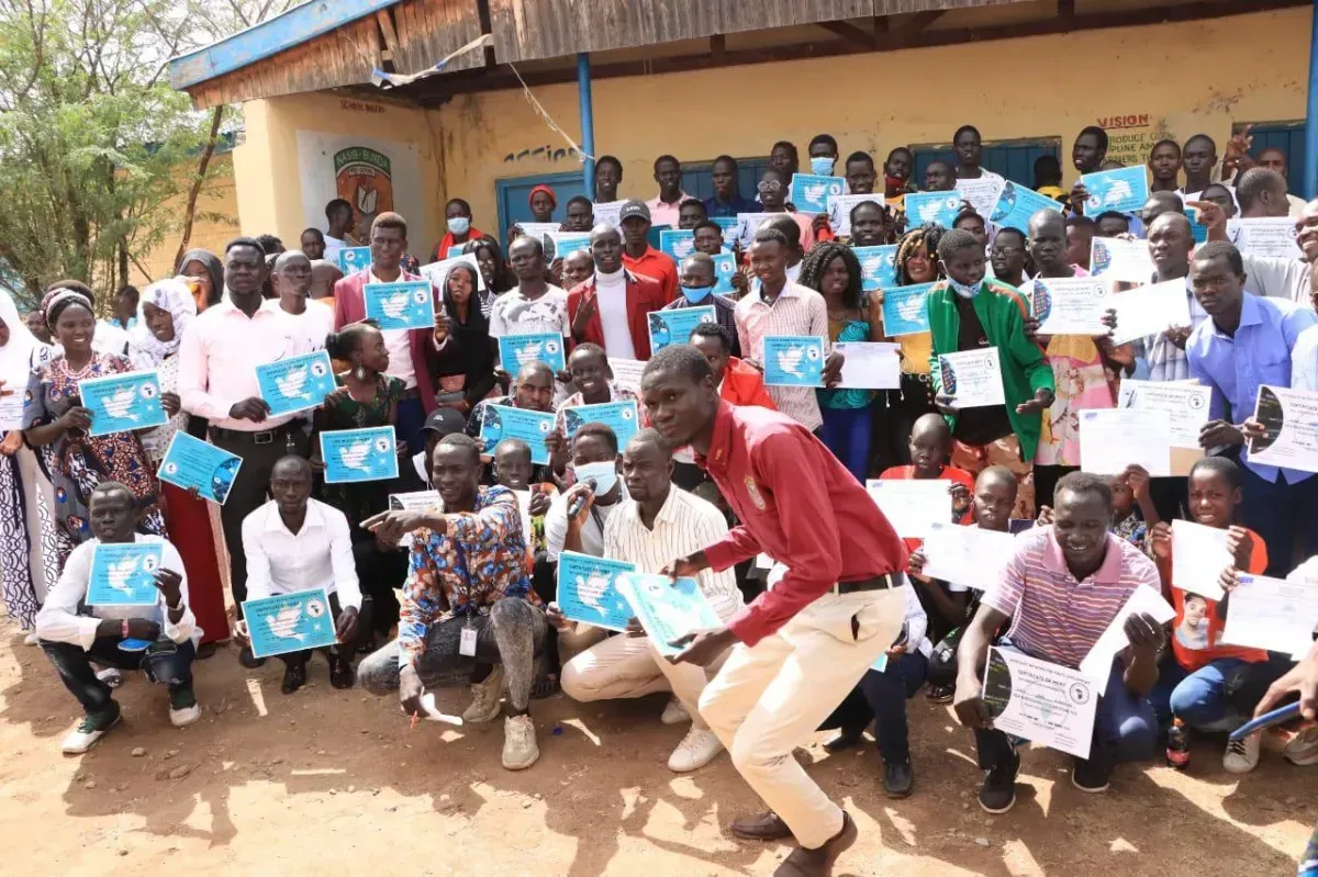 hands formed together with red heart paint